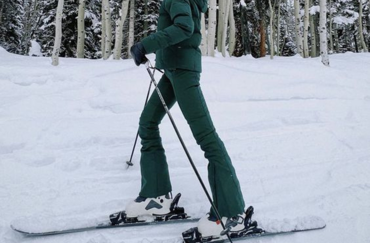 girl wearing green snow pants on ski slope