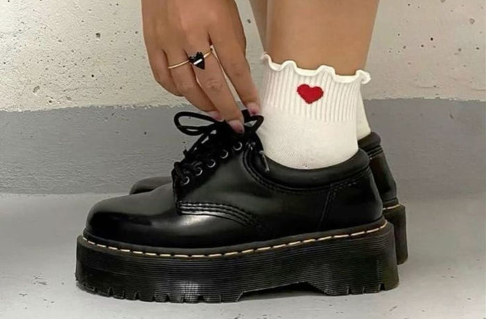 women wearing doc marten platform loafer with white socks