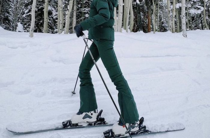 girl wearing green snow pants on ski slope