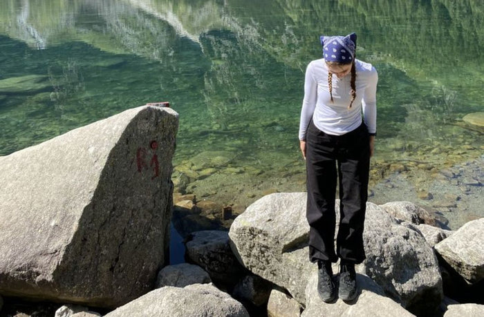 short women hiking by the lake