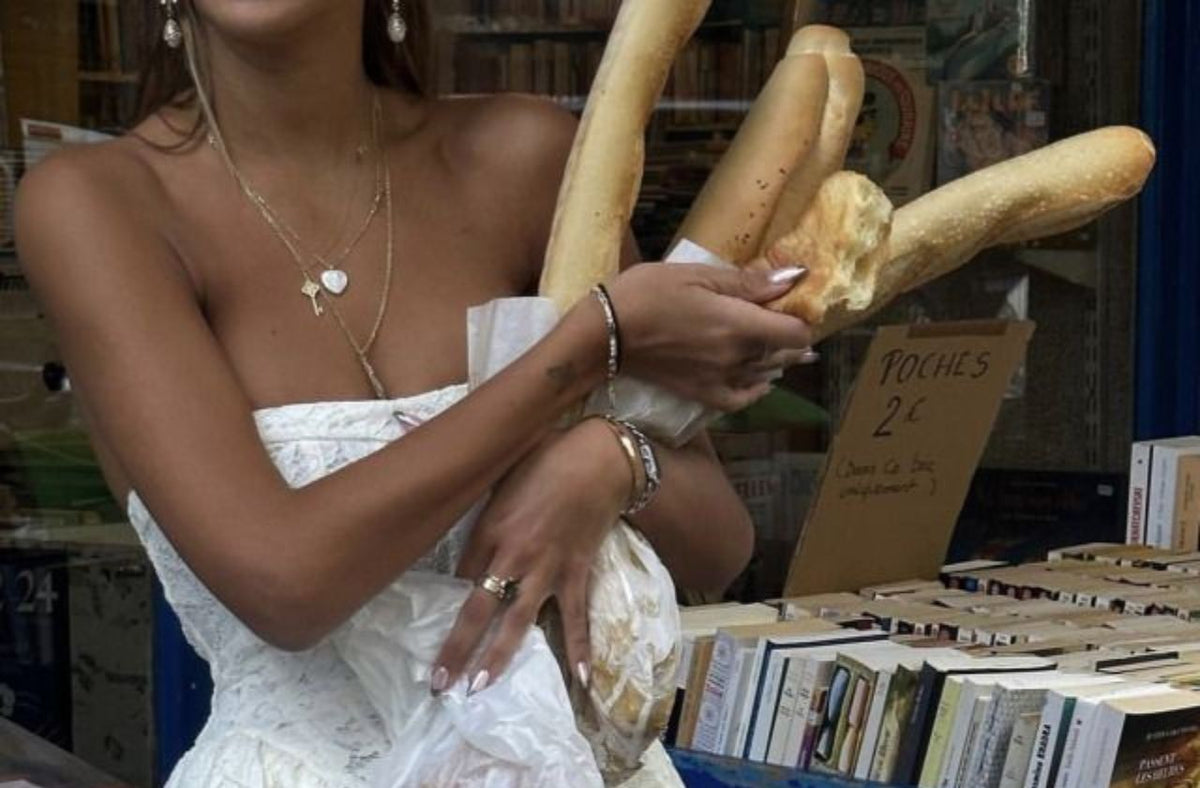 women holding baguette in white chic dress for italy