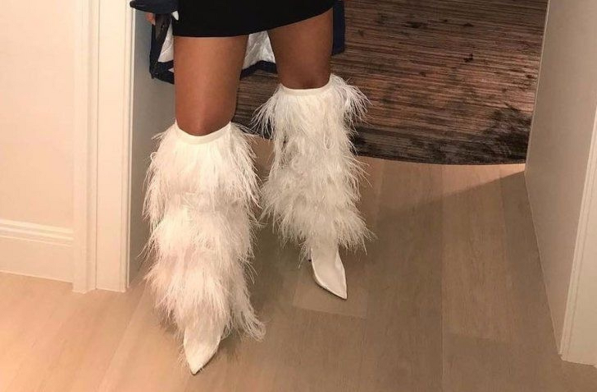 Rihanna in thigh high fur boots 