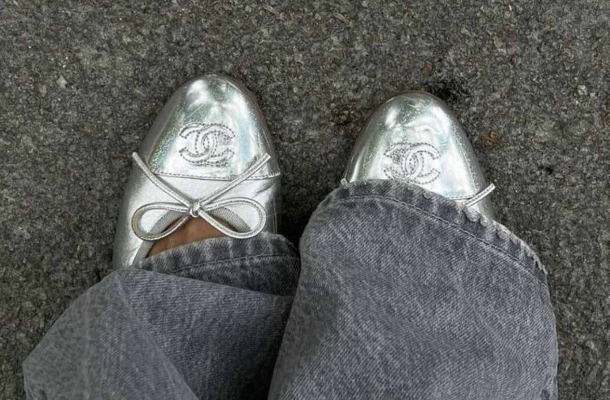 women wearing silver Chanel flats with denim jeans