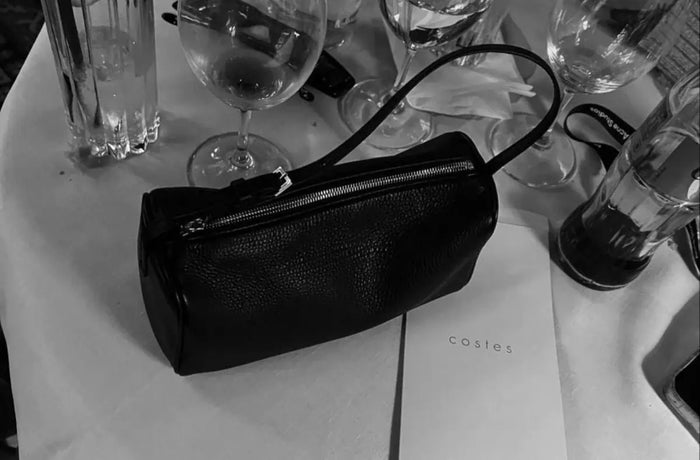the row 90s bag on top of table hotes costes paris