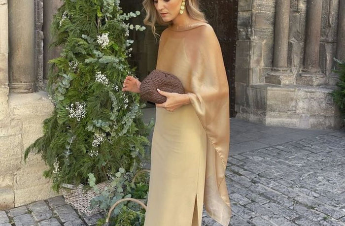 petite women wearing draped shoulder gown gold